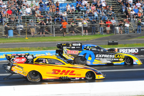 (Matt Hagan (far lane) roared his Mopar to top speed of the event at 326.21 mph)